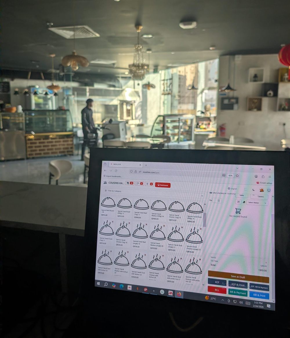 MealNix POS terminal at a bakery counter with the dining area behind