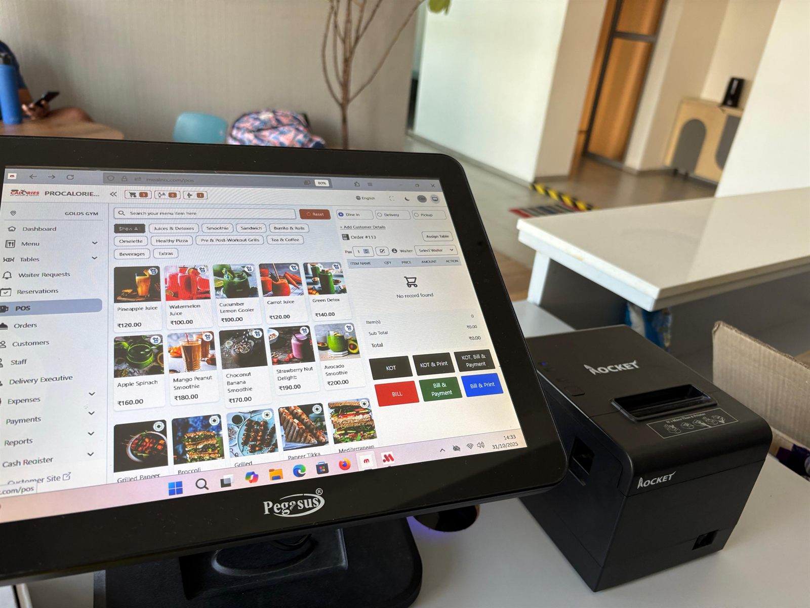 MealNix POS billing screen on a touchscreen terminal beside a thermal receipt printer
